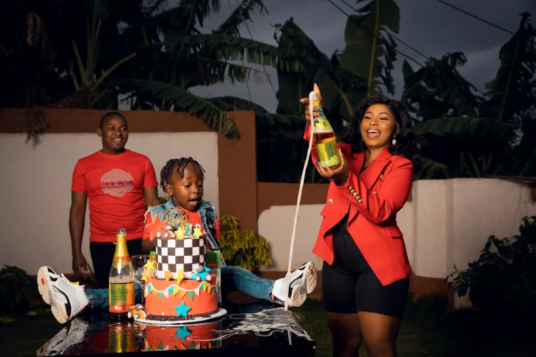 a woman blowing out candles on a birthday cake, an album cover, by Ingrida Kadaka, pexels contest winner, coka-cola advertisement, husband wife and son, full body in shot, making of