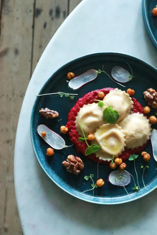 a close up of two plates of food on a table, inspired by Henriette Grindat, unsplash, renaissance, red velvet, dumplings on a plate, amanita, gourmet restaurant