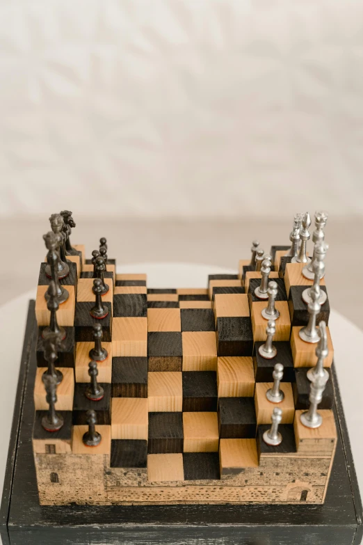 a close up of a chess board on a table, an abstract sculpture, inspired by Peter de Sève, kinetic art, david kassan, small in size, aged, indoor