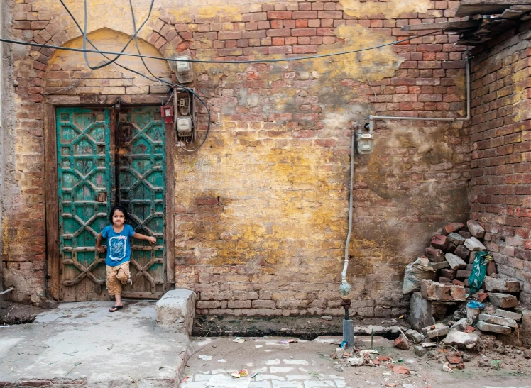 a woman standing in the doorway of a brick building, slums, young boy, dezeen, green alleys