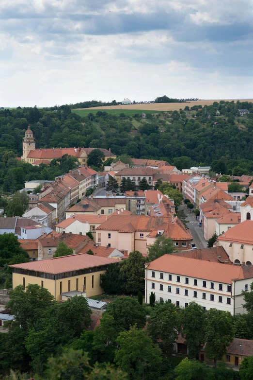 a view of a town from the top of a hill, inspired by Ernő Tibor, romanesque, orange roof, uncropped, square, college