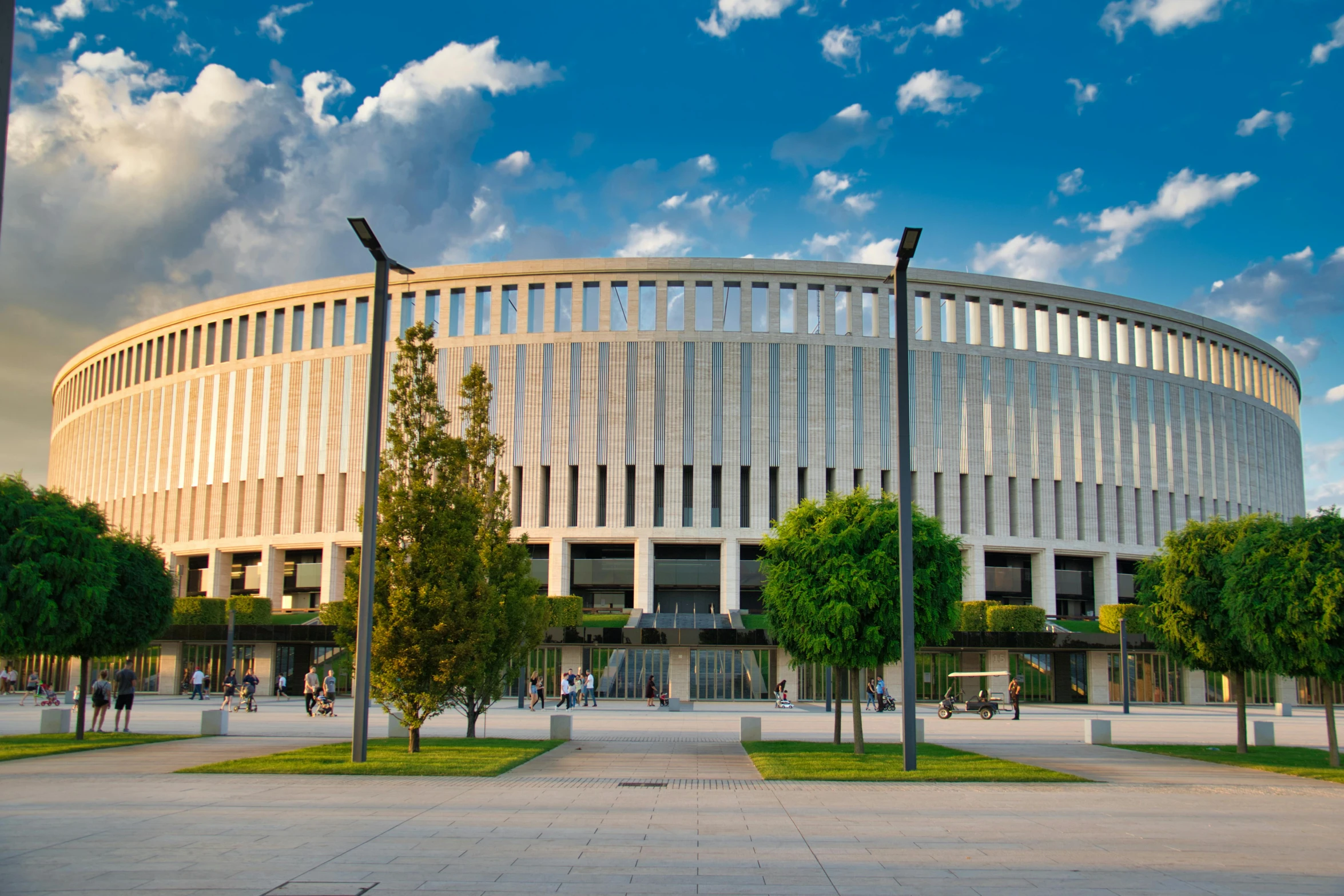 a large white building sitting on top of a lush green field, pexels contest winner, brutalism, in legnica city hall, coliseum, 🚿🗝📝