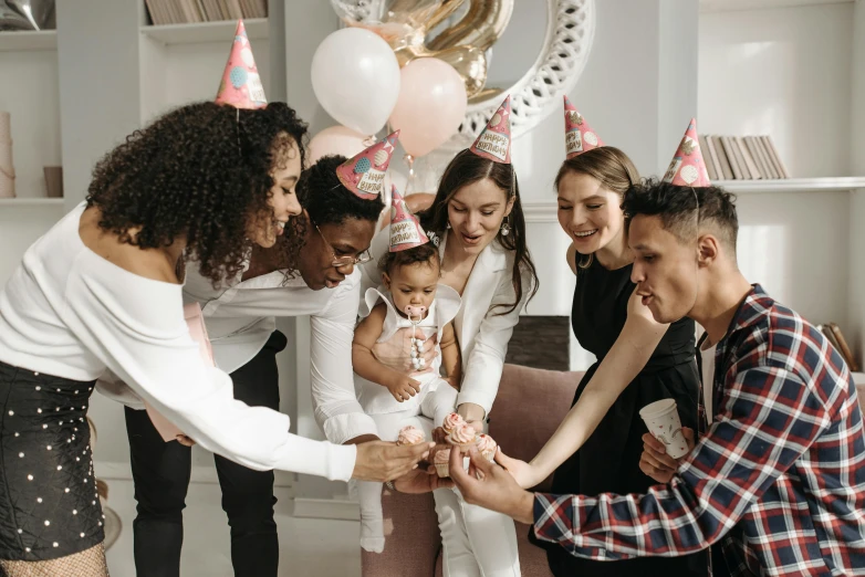 a group of people standing around a birthday cake, by Emma Andijewska, pexels contest winner, diverse outfits, families playing, background image, 2717433015