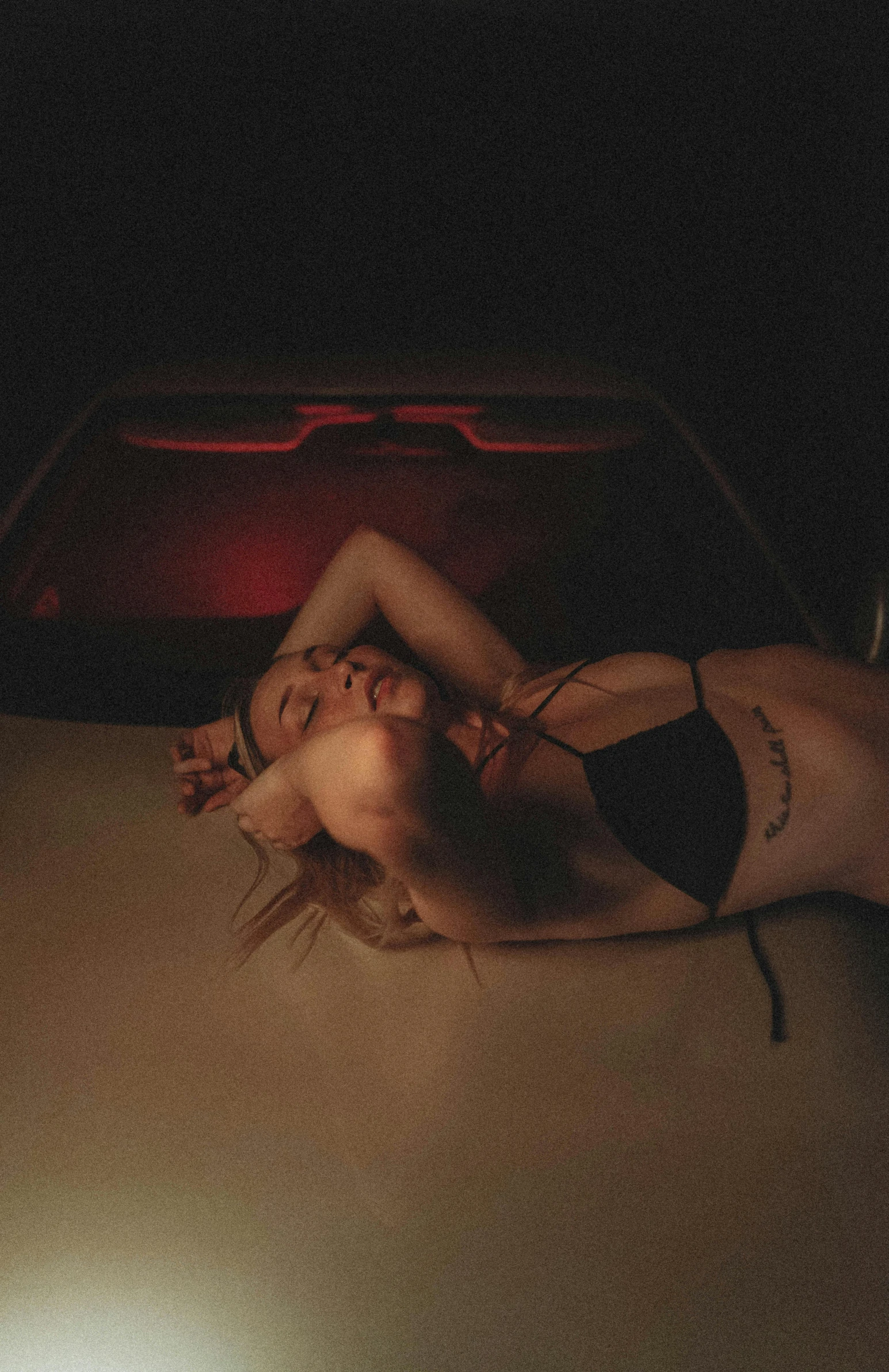 a woman laying on the hood of a car, an album cover, inspired by Elsa Bleda, trending on pexels, blood on body, high quality photo, low cut top, night photo