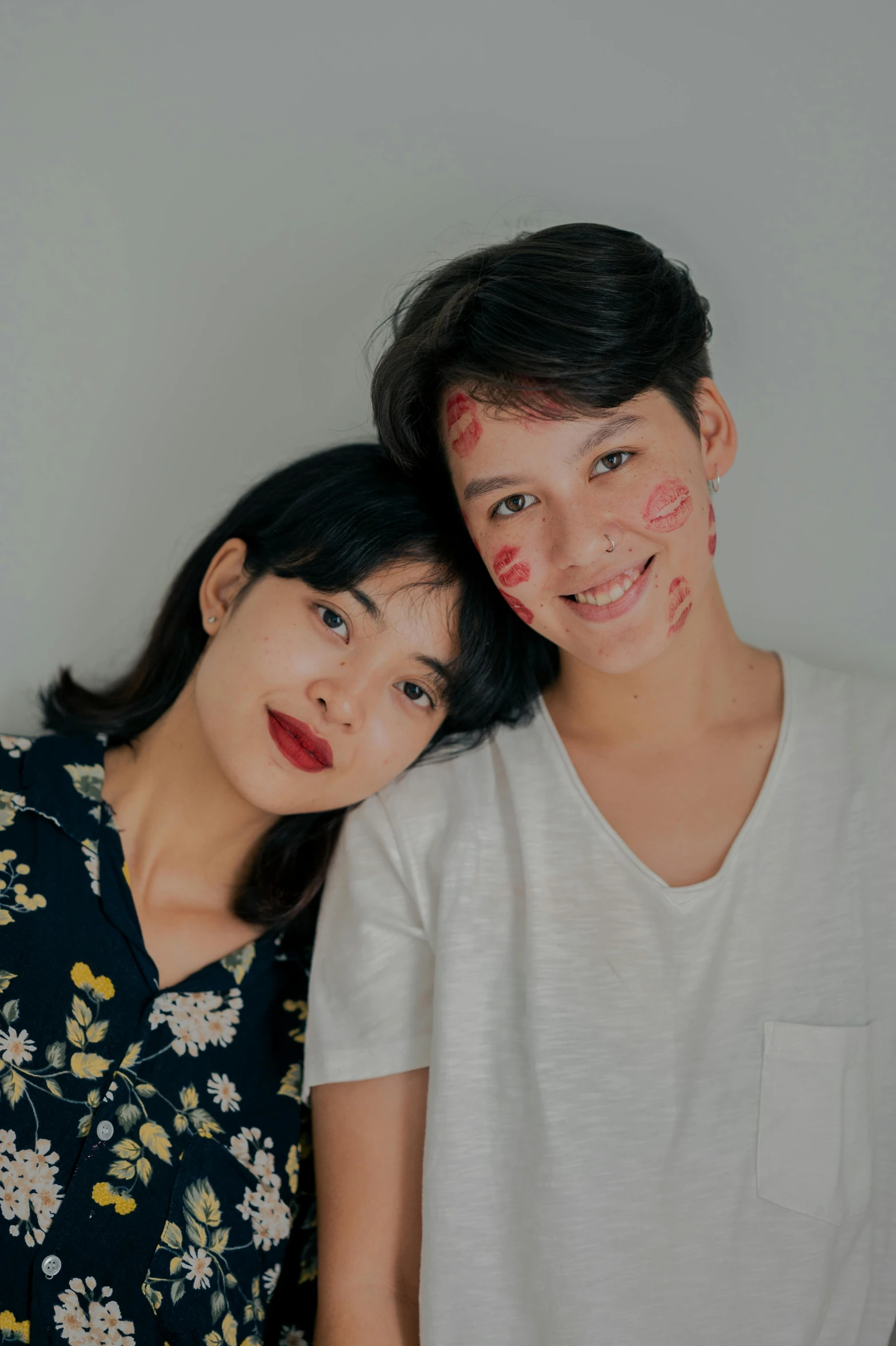 a man and a woman standing next to each other, by Natasha Tan, beauty mark on cheek, genderless, asia, portrait image