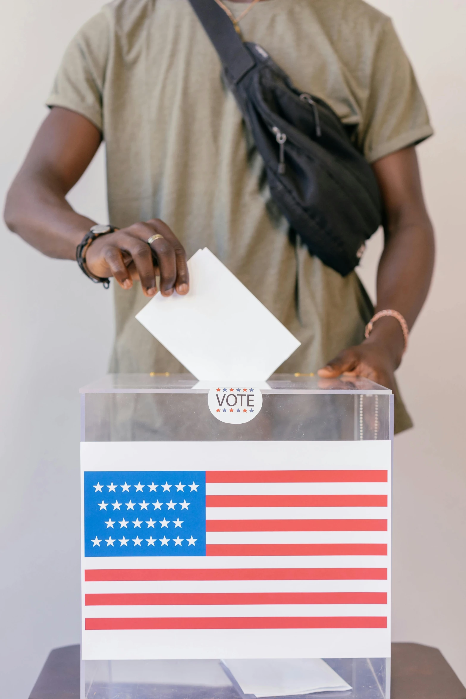 a man putting a voting card into a voting box, trending on unsplash, his cape is the american flag, model posing, trending on getty, laura zalenga