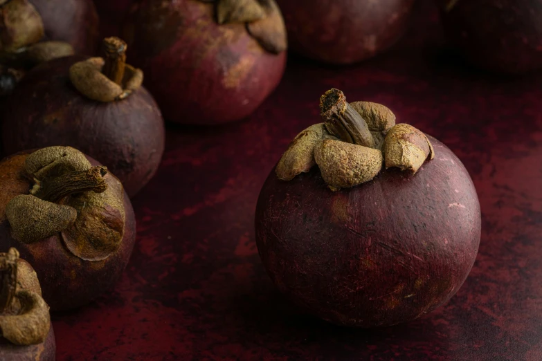 a close up of a bunch of fruit on a table, obsidian pomegranade, brown and magenta color scheme, promo image, medium format