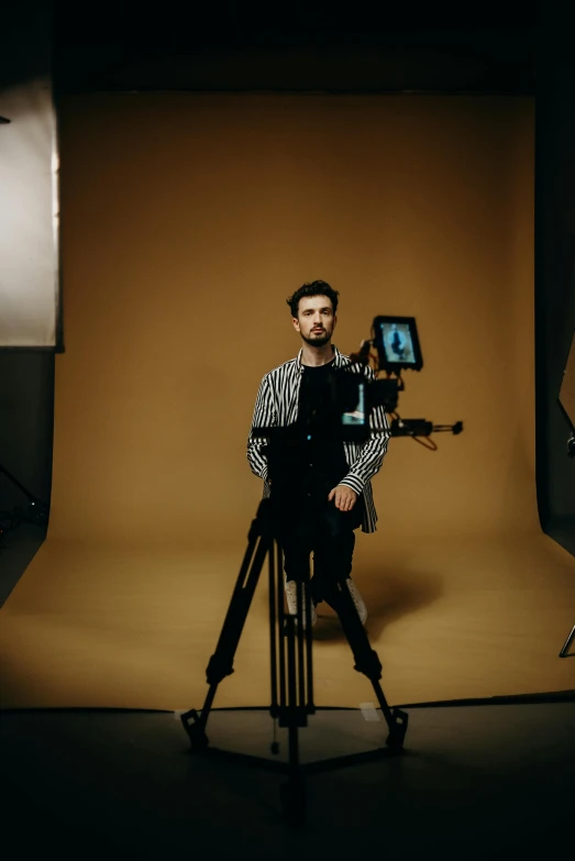 a man that is standing in front of a camera, a picture, movie setup, posing for camera, character posing, facing the camera