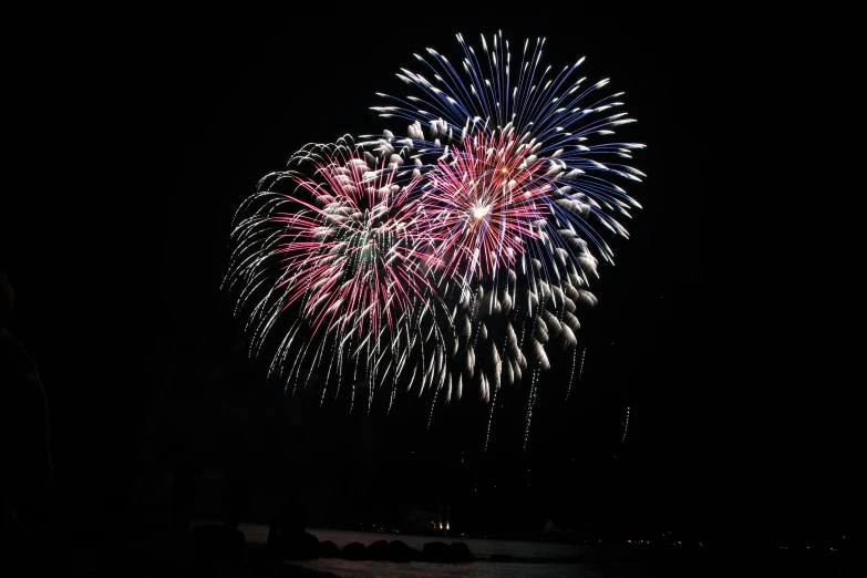 a fireworks is lit up in the night sky, by Sam Dillemans, file photo, 8 k -, close - up photograph, oceanside