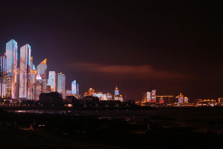 a view of a city lit up at night, pexels contest winner, hyperrealism, zezhou chen, new years eve, panoramic, lightening