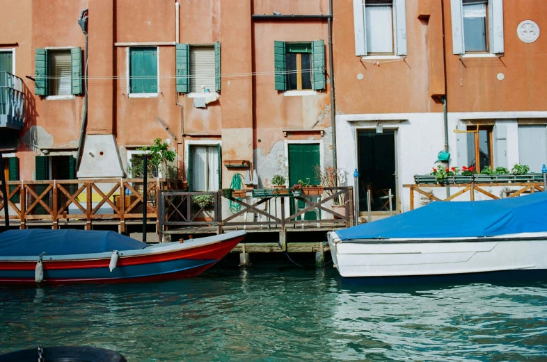 a couple of boats that are in the water, inspired by Quirizio di Giovanni da Murano, pexels contest winner, green alleys, wes anderson style, conde nast traveler photo, 🦩🪐🐞👩🏻🦳