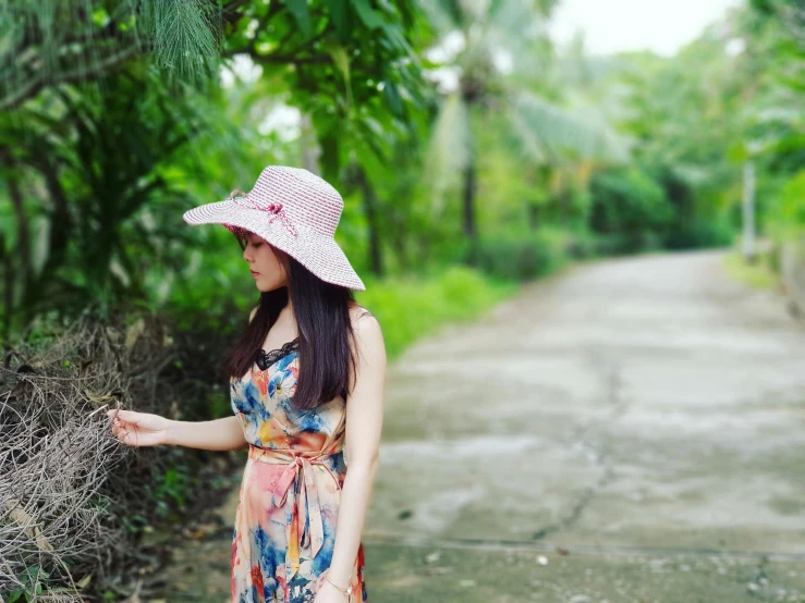 a woman standing in the middle of a dirt road, elegant tropical prints, avatar image, background image, asian girl