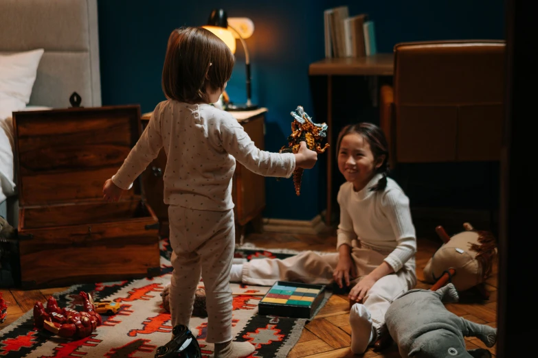 two little girls sitting on the floor playing with toys, by Adam Marczyński, pexels contest winner, figuration libre, standing in a dimly lit room, in the bedroom at a sleepover, a handsome, 15081959 21121991 01012000 4k