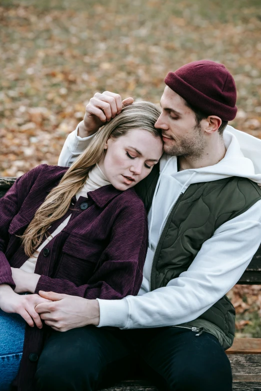 a man and a woman are sitting on a bench, a portrait, trending on pexels, hugging, wearing a beanie, autumn, sleepy feeling