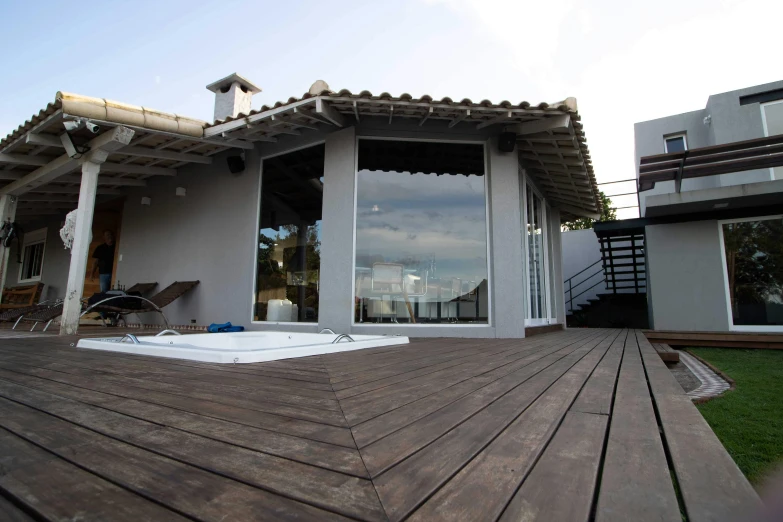 a hot tub sitting on top of a wooden deck, by david rubín, arrendajo in avila pinewood, exterior view, sky view, frontal picture