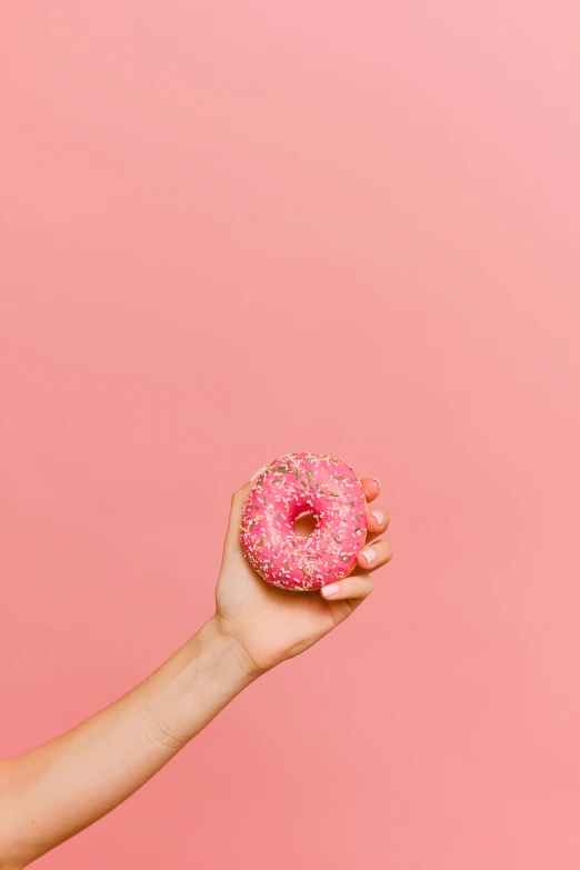 a woman holding a pink donut on a pink background, pexels, 15081959 21121991 01012000 4k, dragon fruits, without text, made of food