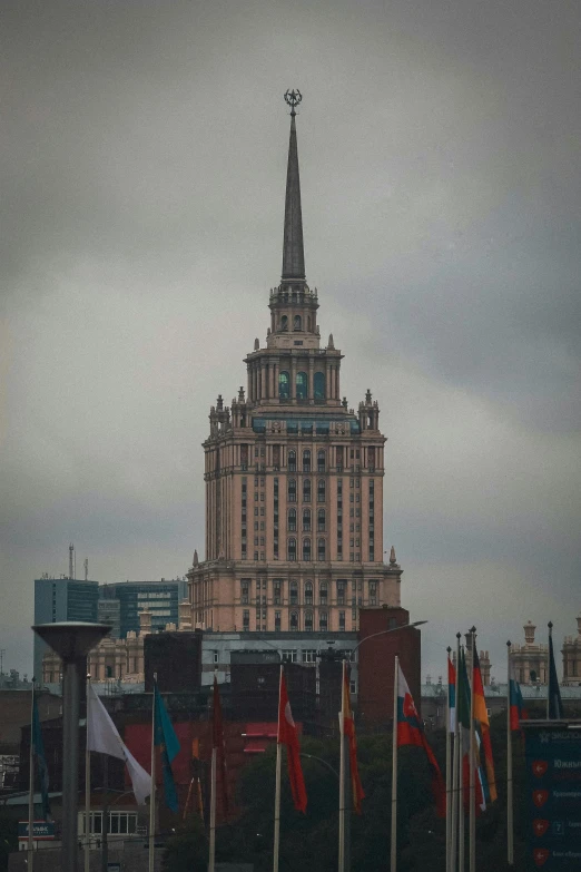 a large building with a spire on top of it, inspired by Vasily Surikov, unsplash, socialist realism, low quality photo, full of skyscrappers, overcast mood, square