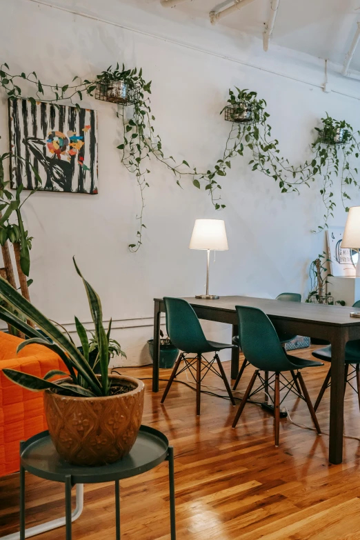 a living room filled with furniture and plants, by Sebastian Vrancx, trending on unsplash, group sit at table, mission arts environment, flowing wires with leaves, slightly minimal