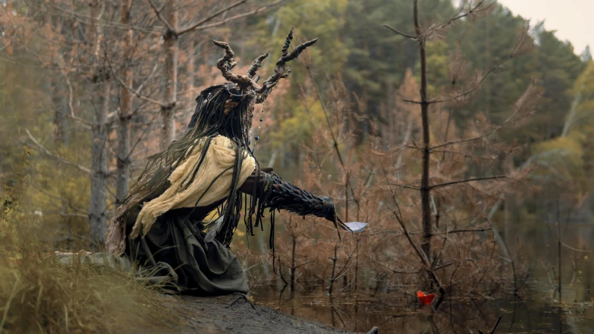 a person dressed as a witch in a forest, by Jesper Knudsen, environmental art, guan yu, a horned, 2022 photograph, lachlan bailey