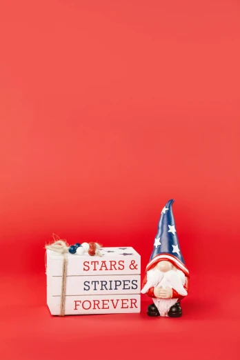 a gnome sitting next to a sign that says stars and stripes forever, by Andries Stock, shutterstock contest winner, emma bridgewater and paperchase, military storage crate, studio shot, red facial stripe