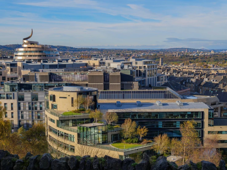 a view of a city from the top of a hill, by John Murdoch, pexels contest winner, brutalism, edinburgh, wide high angle view, research complex, panorama