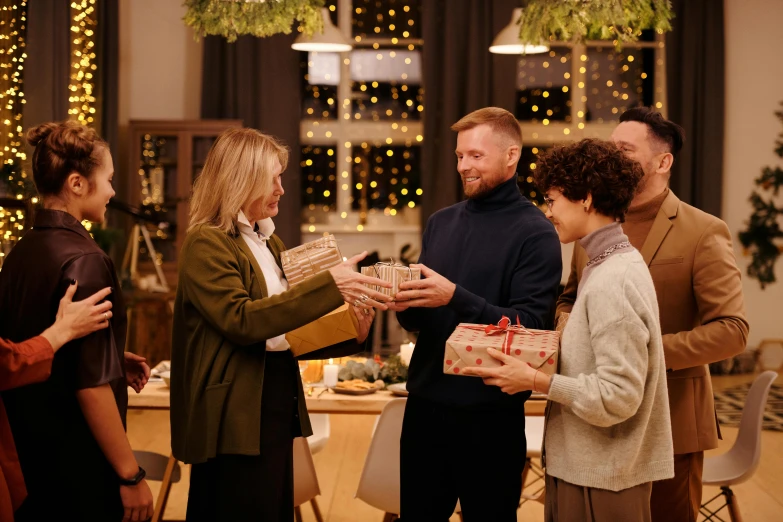 a group of people standing around a table with presents, cozy environment, promo image, unedited, brown