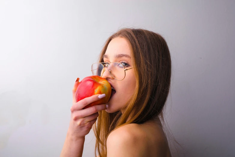 a woman with glasses eating an apple, by Adam Marczyński, trending on pexels, square rimmed glasses, sexy lips :5 stylish, various posed, sentient fruit