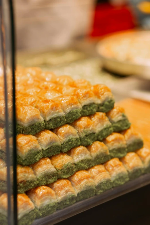 a display case filled with lots of different types of food, hurufiyya, pastel green, close up shot from the side, squares, persian princess