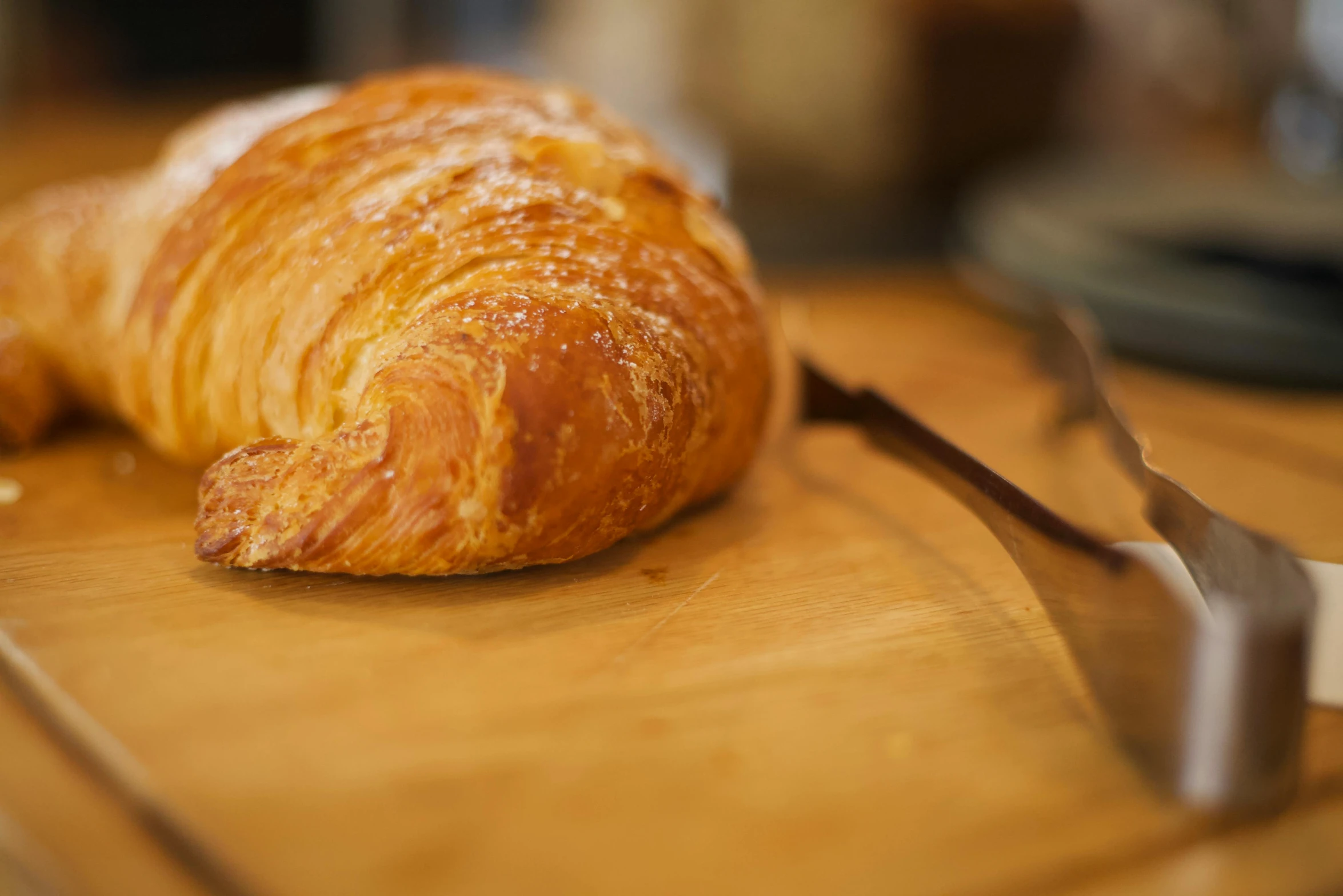 a croissant sitting on top of a wooden cutting board, unsplash, private press, profile image, high-resolution, unedited, sparkling