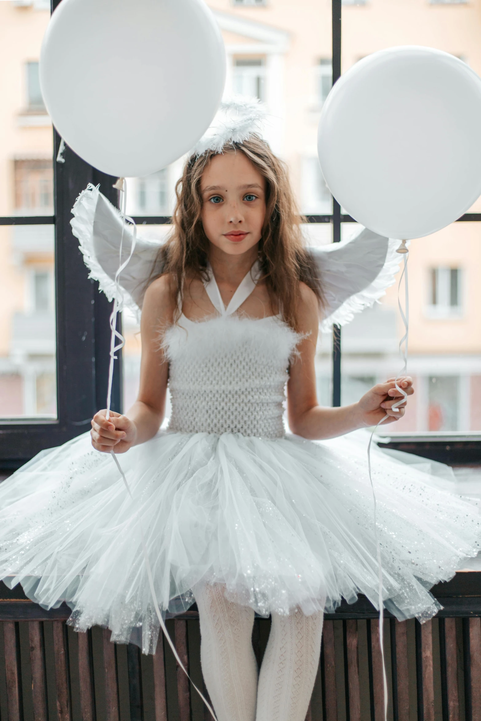 a little girl dressed as an angel sitting on a window sill, a portrait, pexels, on the runway, white and silver, ready - made, fluffy