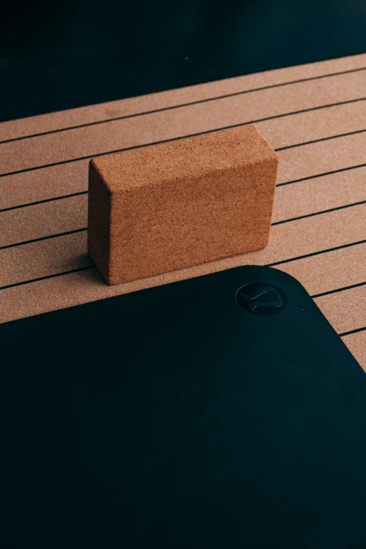 a wooden block sitting on top of a wooden table, all black matte product, boat dock, yoga, kubrik