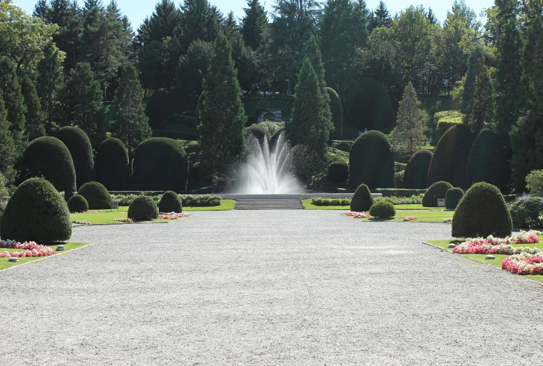 there is a fountain in the middle of the park, pexels contest winner, bushes in the background, washington state, thumbnail, located in a castle