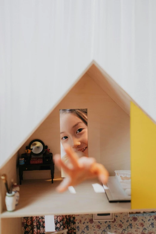 a little girl that is inside of a doll house, a picture, unsplash, conceptual art, origami studio 3 design, mirror selfie, close up shot from the top, joy ang