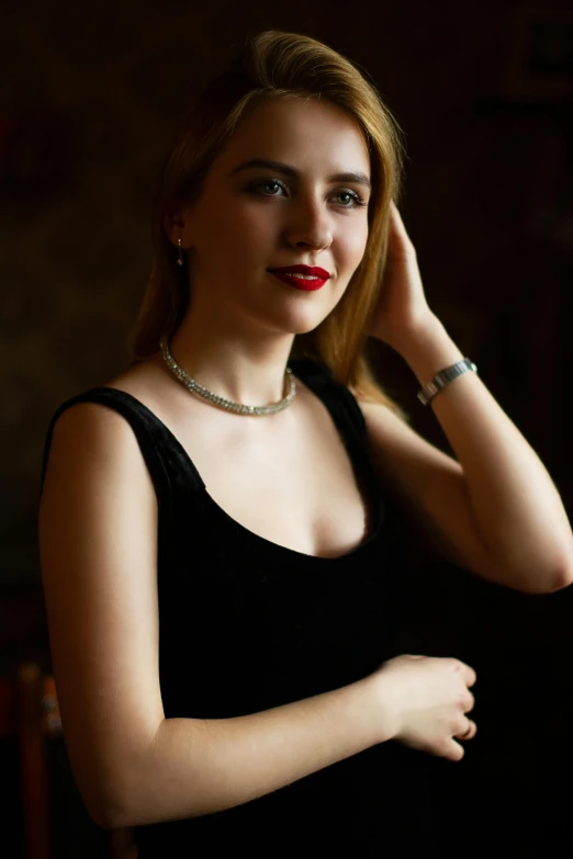 a woman in a black dress posing for a picture, a portrait, inspired by Peter Basch, pexels contest winner, silver necklace, medium format. soft light, promo image, style of alexander trufanov