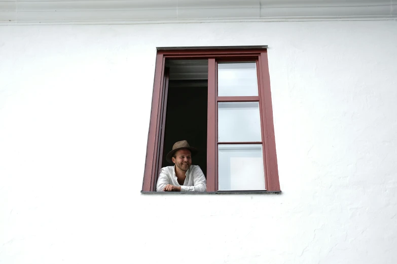 a man that is looking out of a window, pexels contest winner, quito school, caracter with brown hat, in white room, square, avatar image