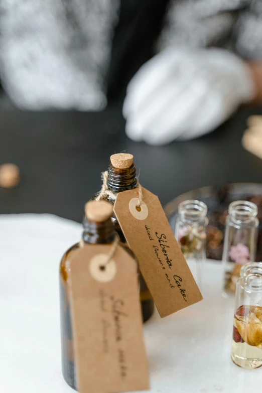 a group of small bottles sitting on top of a table, a picture, label, botanicals, brown, thumbnail