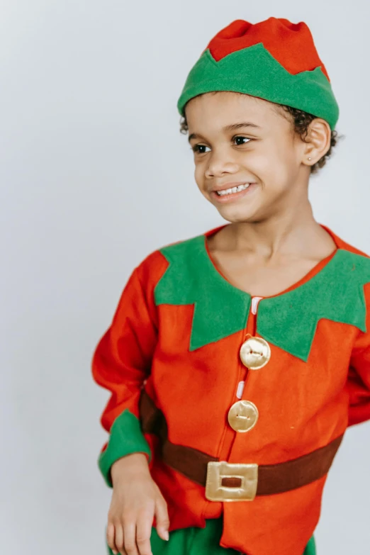 a little boy dressed up as a elf, inspired by Kate Greenaway, orange and green power, official product photo, detail, cheery