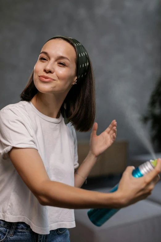 a woman spraying a christmas tree with a spray can, pexels contest winner, oily skin, smiling young woman, avatar image, indoor shot