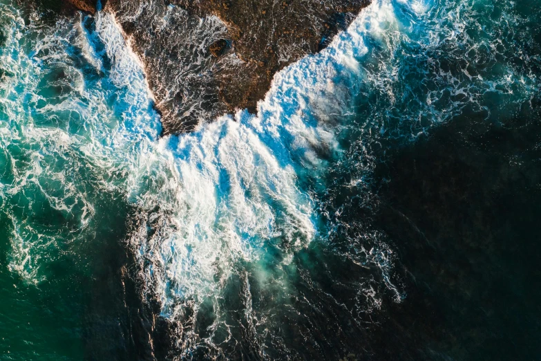 a large body of water next to a rocky shore, pexels contest winner, happening, azure waves of water, taking from above, overflowing energy, unsplash photo contest winner