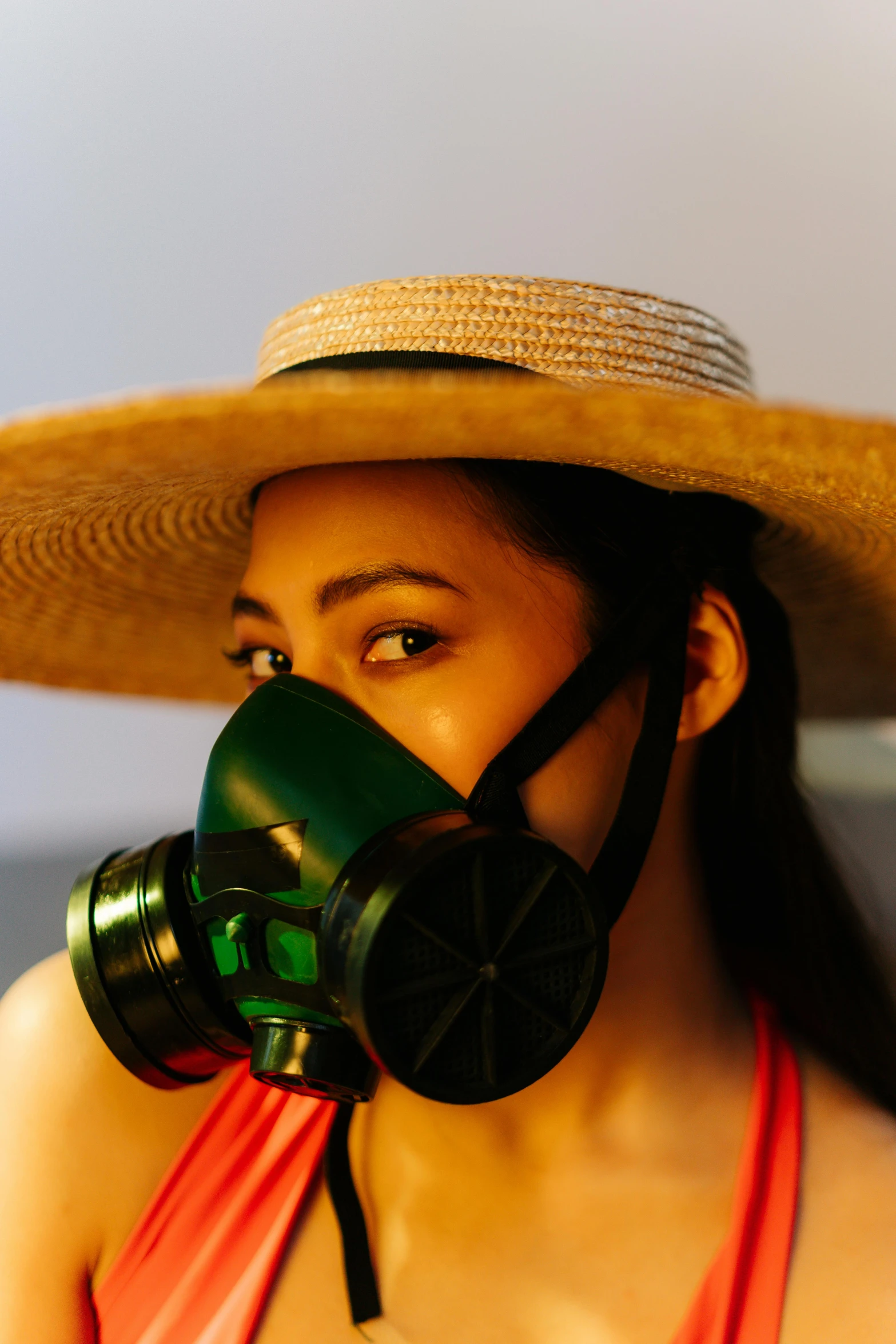 a woman wearing a hat and a gas mask, an album cover, pexels contest winner, green: 0.5, asian female, straw, bio - chemical