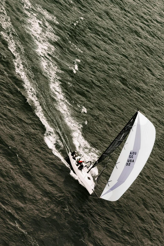 a person windsurfing on a body of water, looking down from above, octane 1 2 8 k, skiff, upon a peak in darien