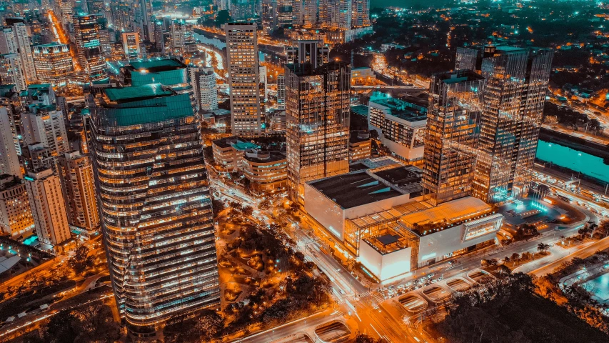 an aerial view of a city at night, pexels contest winner, philippines, orange and cyan lighting, modern buildings, low detailed