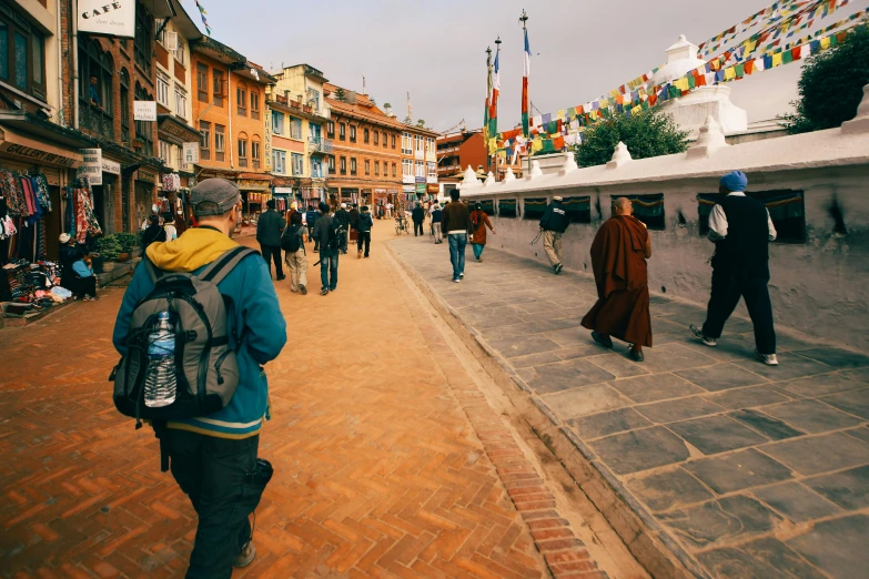 a group of people walking down a street, by Sam Dillemans, unsplash contest winner, hurufiyya, thangka, city square, brown, trecking
