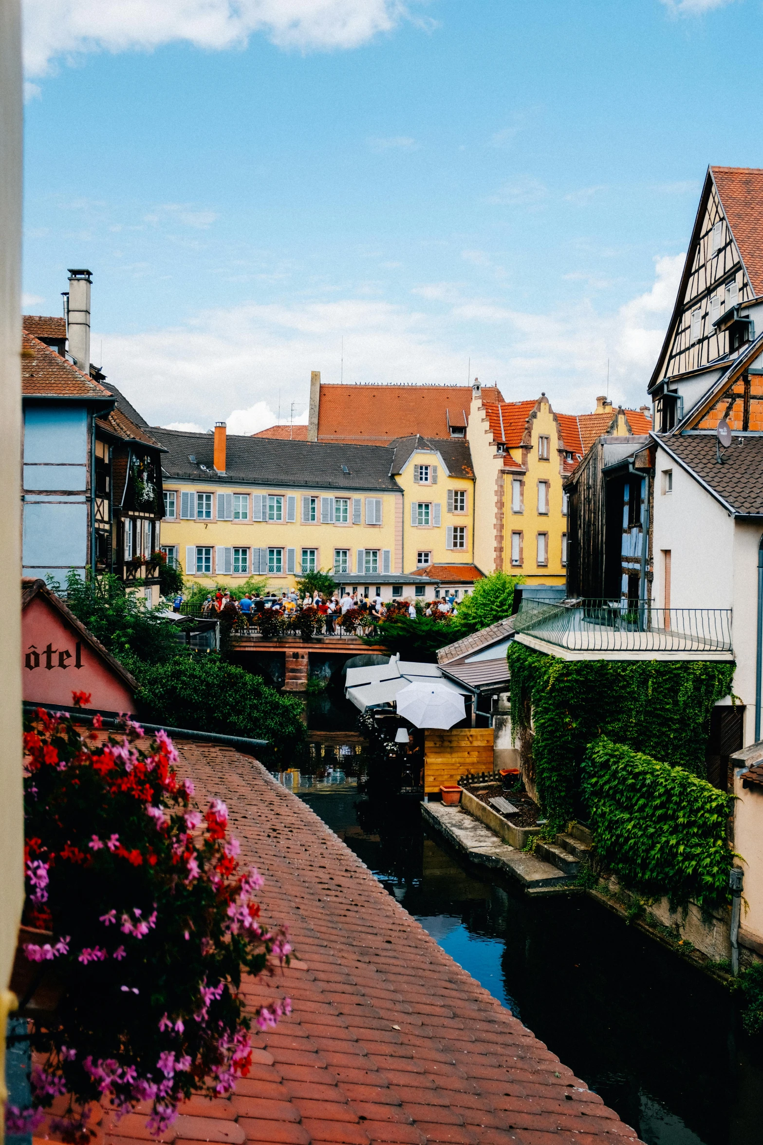 a river running through a small town next to tall buildings, renaissance, french village exterior, festivals, lush, subtle colors