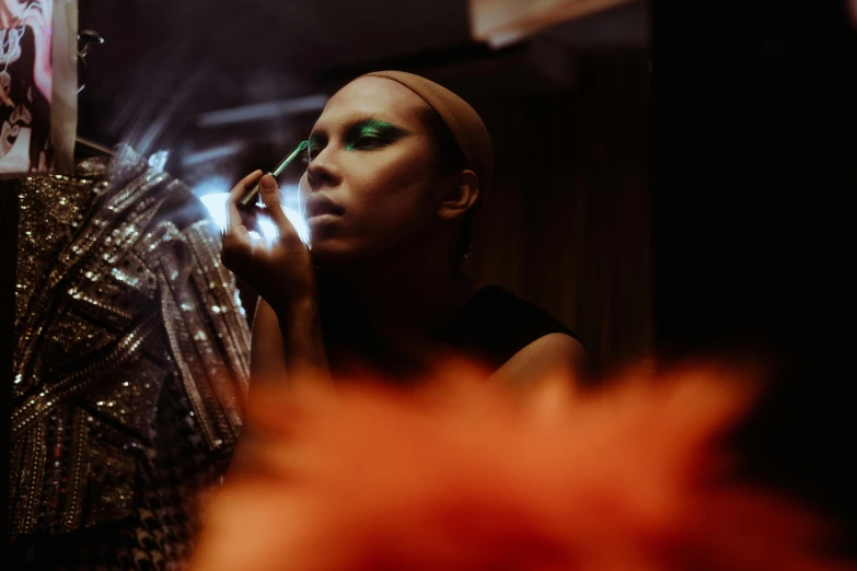 a woman talking on a cell phone in front of a mirror, a portrait, by Julia Pishtar, pexels contest winner, visual art, drag, evening makeup, grace jones, wearing eye shadow