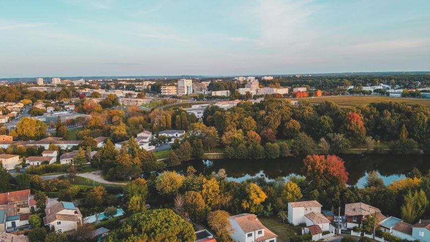 an aerial view of a small town surrounded by trees, inspired by Washington Allston, pexels contest winner, winnipeg skyline, northern france, fall season, 90s photo