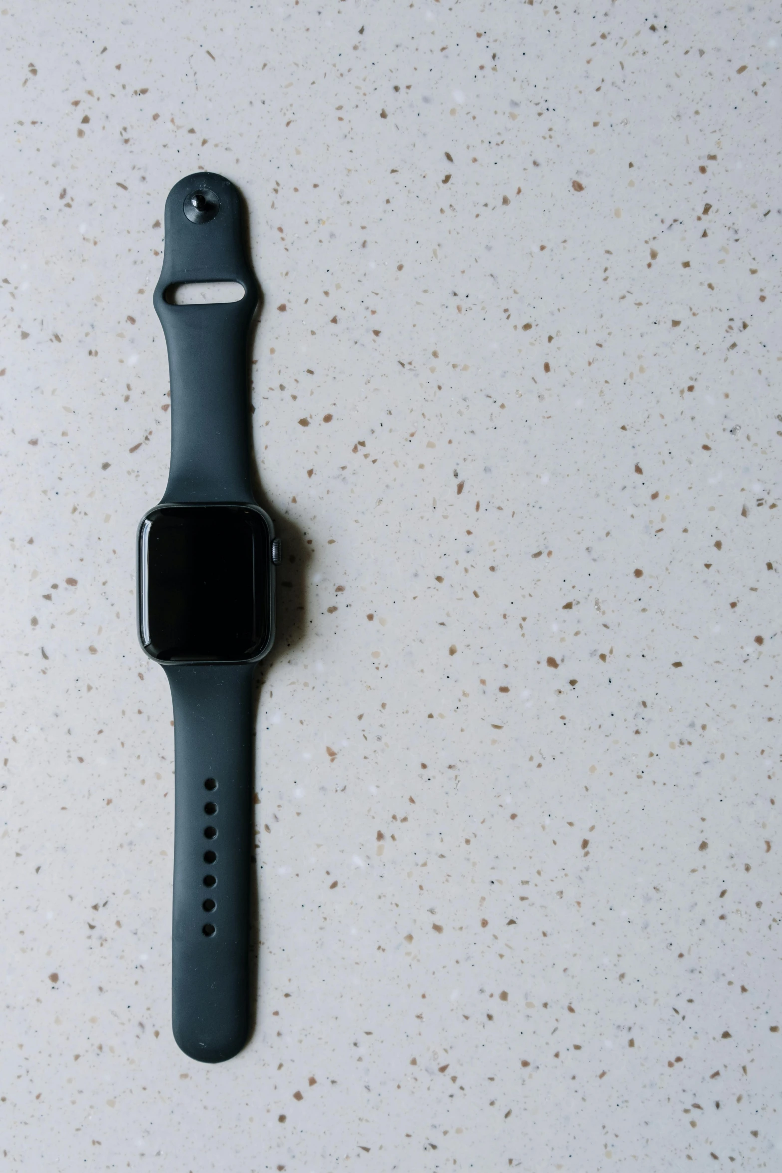 an apple watch sitting on top of a table, by Carey Morris, unsplash, minimalism, black plastic, tall, square, wall