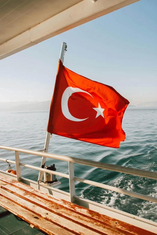 a turkish flag on the deck of a boat, by Carey Morris, pexels, hurufiyya, 2 5 6 x 2 5 6, slide show, ocean view, tourist photo