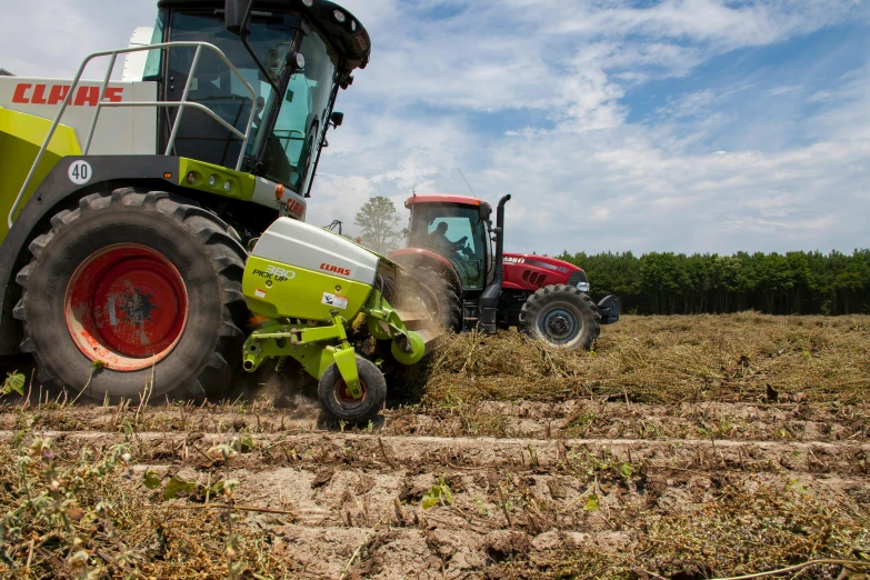 a couple of tractors that are in the dirt, a portrait, flickr, picking up a can beans, avatar image, high quality image, surrounding onions