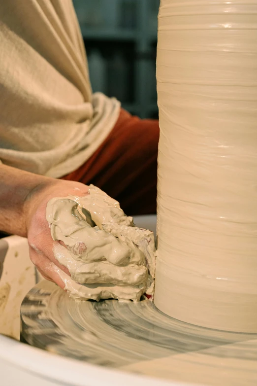 a person making a vase on a potter's wheel, a marble sculpture, inspired by Hendrik Gerritsz Pot, promotional image, thumbnail, petite, long